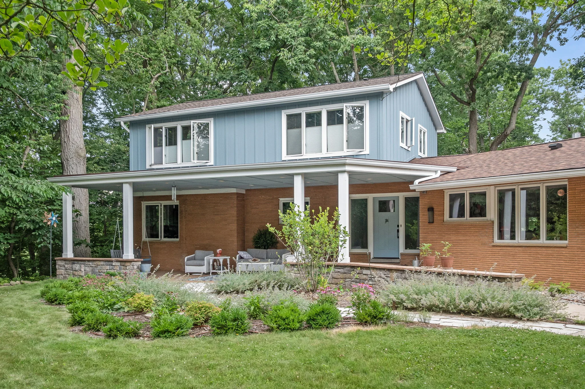 Blue exterior addition on a brick home